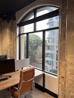 Natural light filled co-working desks in contemporary, industrialist wool-shed conversion, dedicated desk at Ultimo creative workspace, image 1
